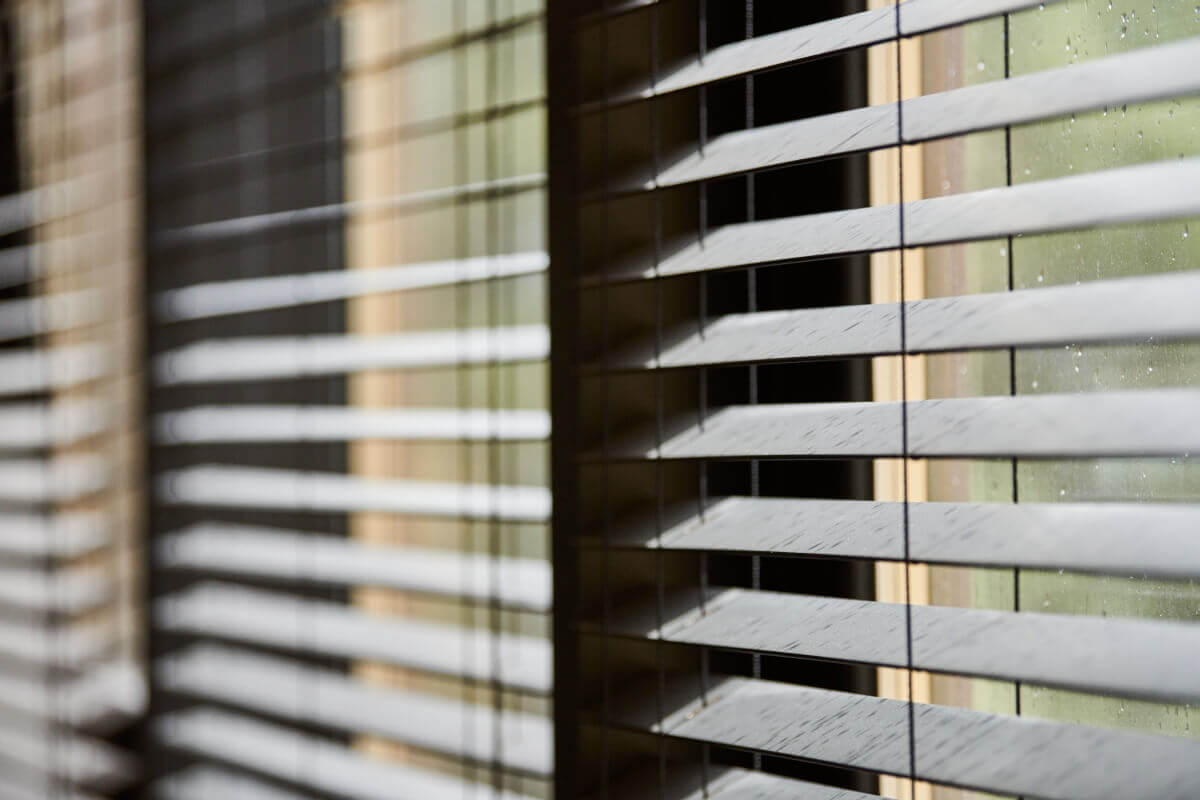 Movable bespoke wooden blinds mounted on a large window.